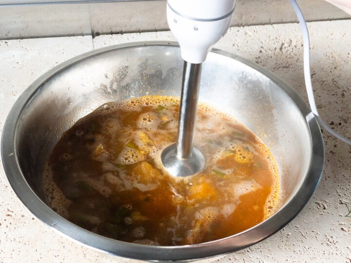 The cooked prawn bisque is blitzed in a mixing bowl with an immersion/stick blender.