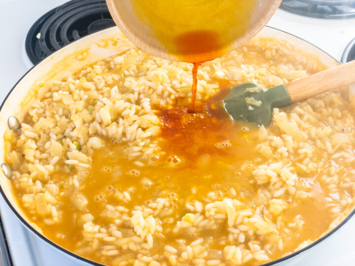 Saffron water is added to prawn risotto near the end of cooking.