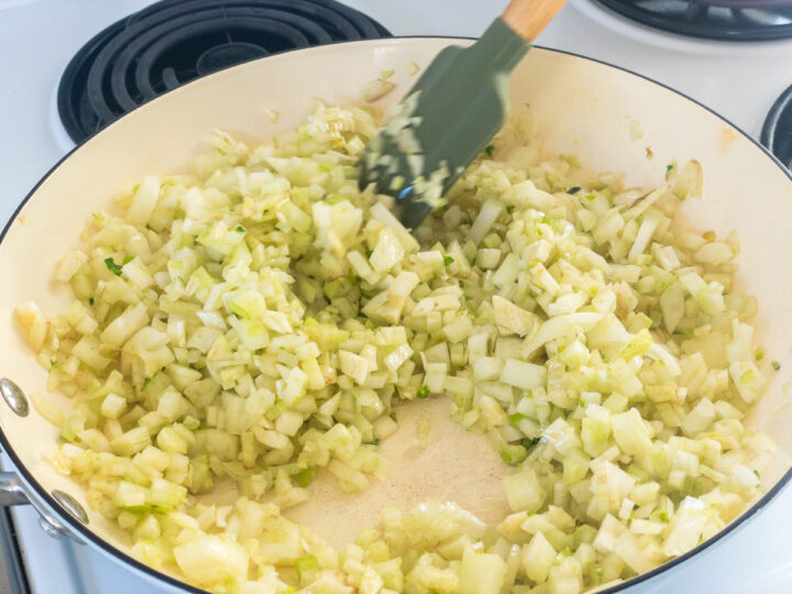 Diced fennel and onion is fried in olive oil in a pan over medium heat.