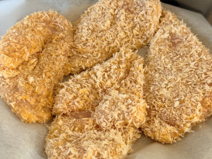 Chicken cotoletta coated with panko breadcrumbs, ready for frying and baking.