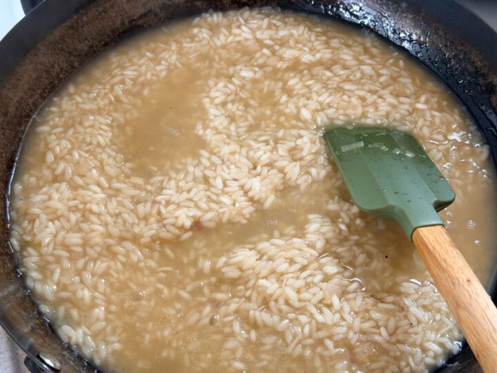 Risotto being cooked with chicken stock